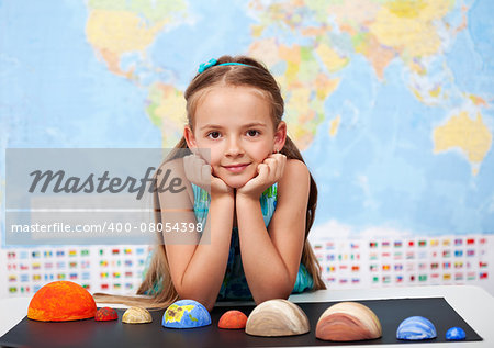 Little girl in elementary science class with her home project - the planets of our solar ystem