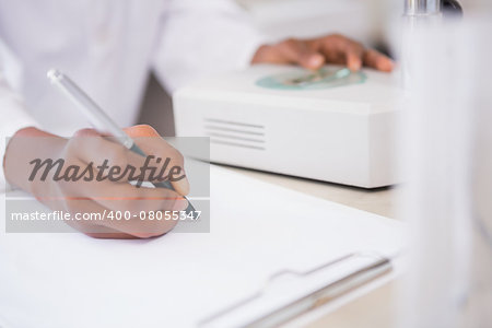 Scientist taking notes in laboratory