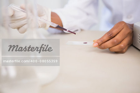 Scientist working attentively with pipette in laboratory
