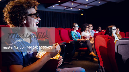 Young friends watching a 3d film at the cinema