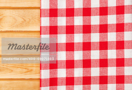 Red towel over wooden kitchen table. View from above with copy space