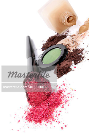 Pink make up powder on make up brush, ground beige and brown make up and foundation isolated on white background. Feminine beauty concept.