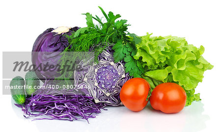 Whole and sliced red scotch kale with tomatoes, cucumbers, lettuce, parsley and dill isolated on white background.