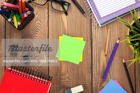 Office table with flower, supplies and blank post it for copy space