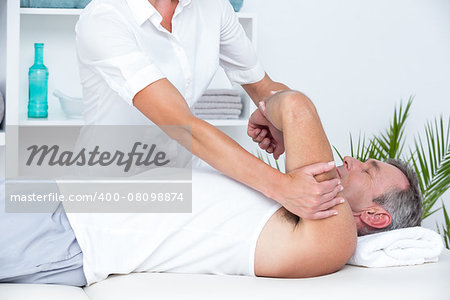 Doctor examining her patient arm in medical office