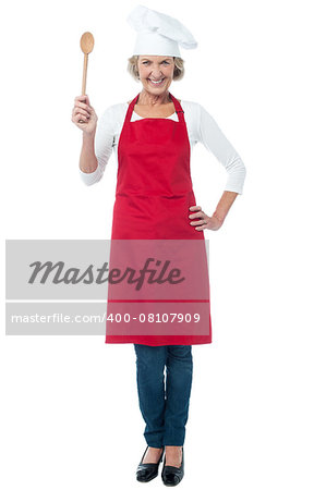 Joyous smiling aged female chef holding spoon