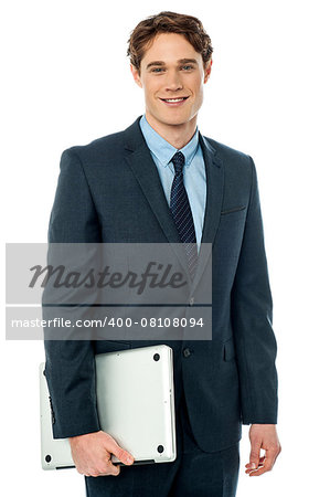 Young stylish businessman holding laptop