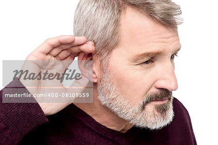 Mature man cupping his hand behind ear