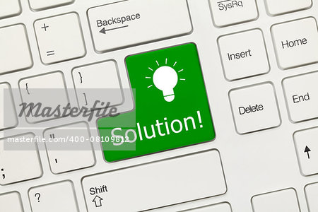 Close-up view on white conceptual keyboard - Solution (green key)