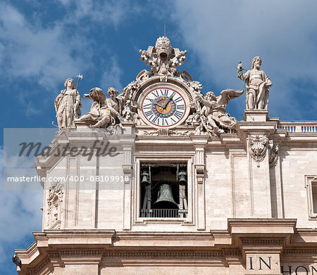 Maderno's facade with the sculptures and clock against the sky background. St. Peter's Basilica -  Vatican City.
