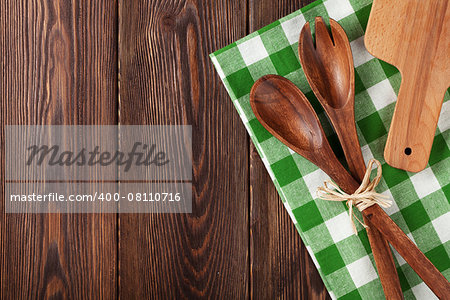 Kitchen cooking utensils over wooden table background. Top view with copy space
