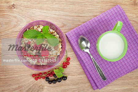 Healthy breakfast with muesli and milk. View from above on wooden table