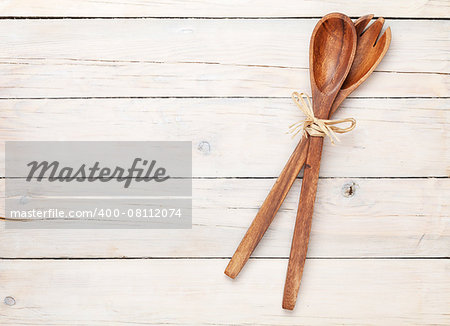Kitchen utensils over white wooden table background. View from above with copy space