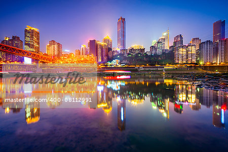 Chongqing, China riverside cityscape at night on the Jialing River.