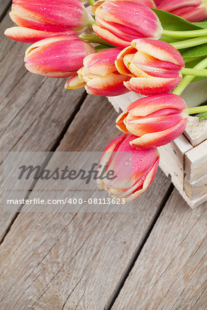 Colorful tulips on wooden table. Top view with copy space