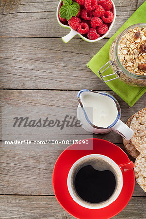 Healthy breakfast with muesli, berries and milk. On wooden table with copy space