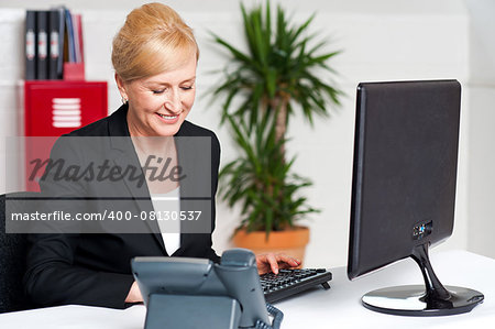 Business woman working on computer at her office