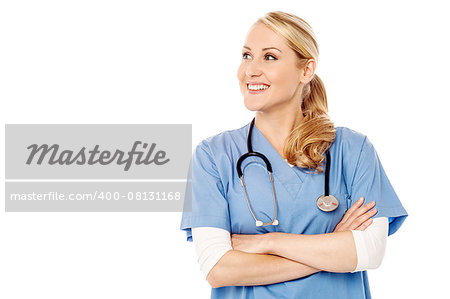 Beautiful nurse with folded arms, looking away