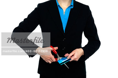 Cropped image of a woman in formals cutting credit card with scissors.