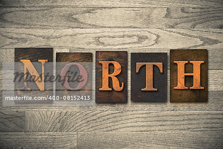 The word "NORTH" theme written in vintage, ink stained, wooden letterpress type on a wood grained background.