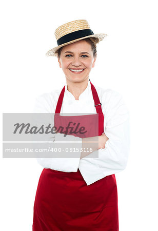 Lady cook in white red uniform wearing trendy hat and posing with crossed arms