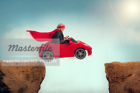 active senior superhero driving a car off a ravine