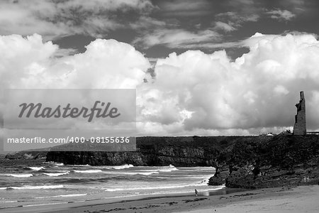 young woman on the beach with cliffs and castle on ballybunion beach county kerry ireland