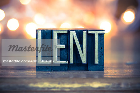 The word LENT written in vintage metal letterpress type on a soft backlit background.