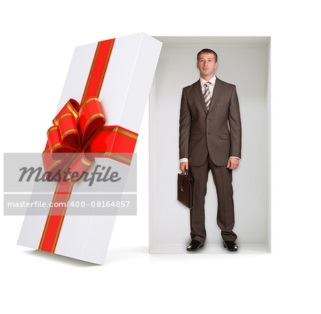 Businessman with suitcase in gift box with ribbon on isolated white background