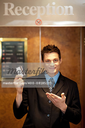 Snap shot of handsome guy holding cash card and showing it to camera