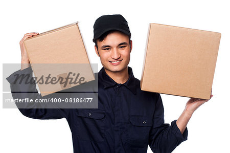 Young delivery boy at work carrying carton boxes on shoulders