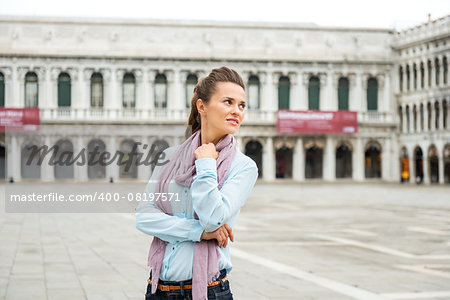 A woman, deep in thought, looks over her shoulder at all the surrounding beauty and grandeur of an empty St. Mark's Square in Venice. What a rare privilege.