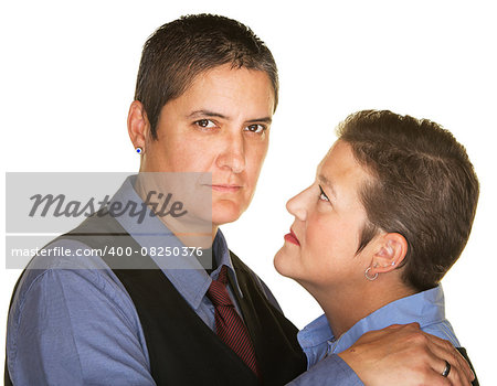 Serious gay couple holding each other over isolated background