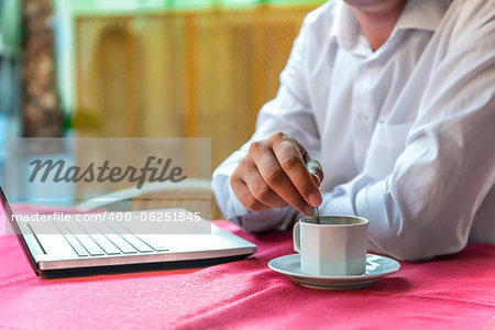 breakfast businessman with a laptop in a cafe
