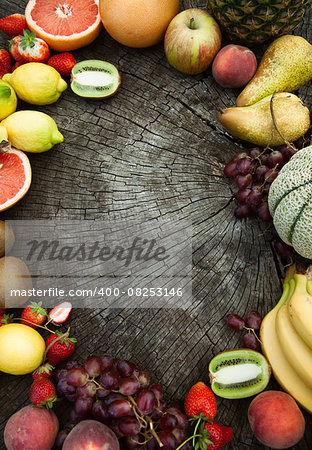 Fresh fruit. Fruit variety on wood. Food background. Tropical fruit