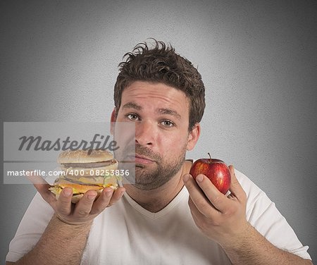 Man undecided between diet and junk food