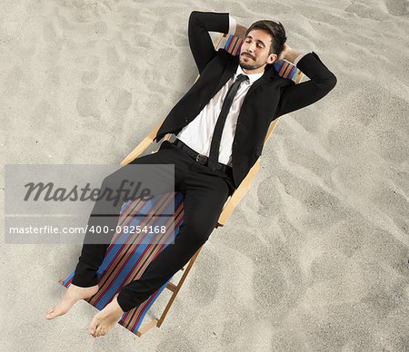 Businessman relaxes lying on a beach chair