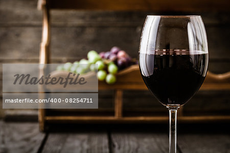 Red wine with grapes. Fresh grapes on wood. Autumn fruit
