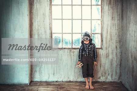 Little boy with airplane in the studio