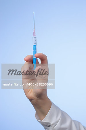 Hand of a female doctor with syringe