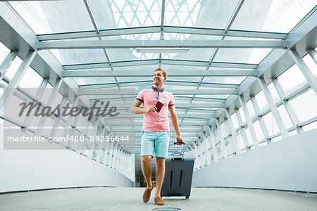 Young man with a suitcase at the airport