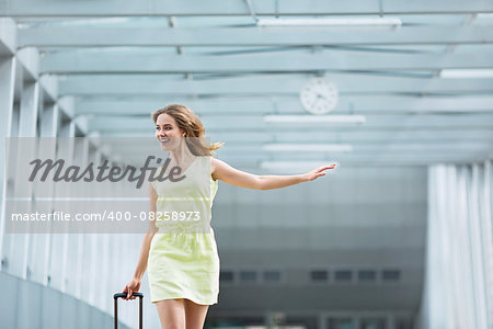 Young girl with a suitcase at the airport
