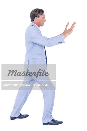 Businessman walking while gesturing with hands on a white background