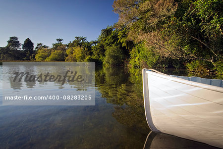 Front of small wooden row boat, with reflections, Lake Rotorua, New Zealand