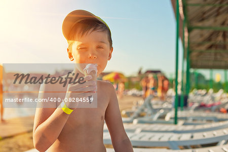 Baby boy with ice-cream at the beach