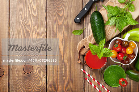 Fresh vegetable smoothie on wooden table. Tomato, cucumber, pepper. Top view with copy space