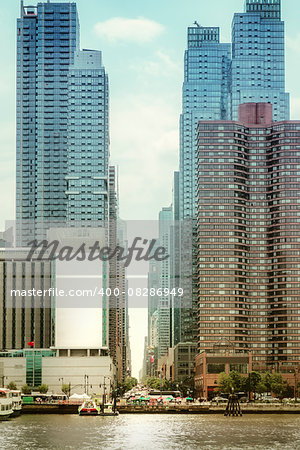 An image of some high rise buildings in New York with an advertising wall
