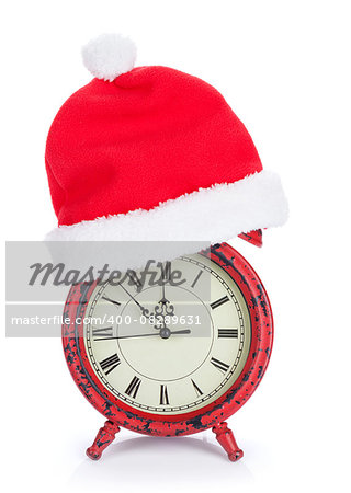 Christmas clock with santa hat. Isolated on white background