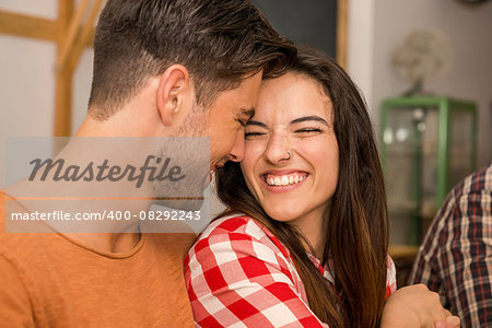 Happy couple at the restaurant talking and smiling