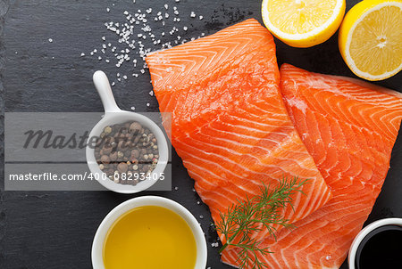 Salmon and spices on stone table. Top view